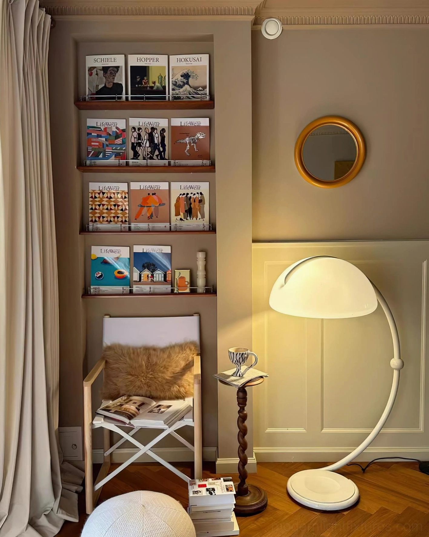 White Serpente articulated floor lamp in industrial modern loft space with exposed elements