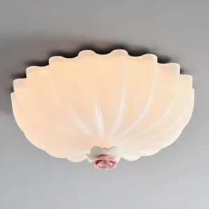 Illuminated Belle Coquille ceiling lamp glowing with warm white 3000K LED light, frosted glass shell design with romantic pink floral detail