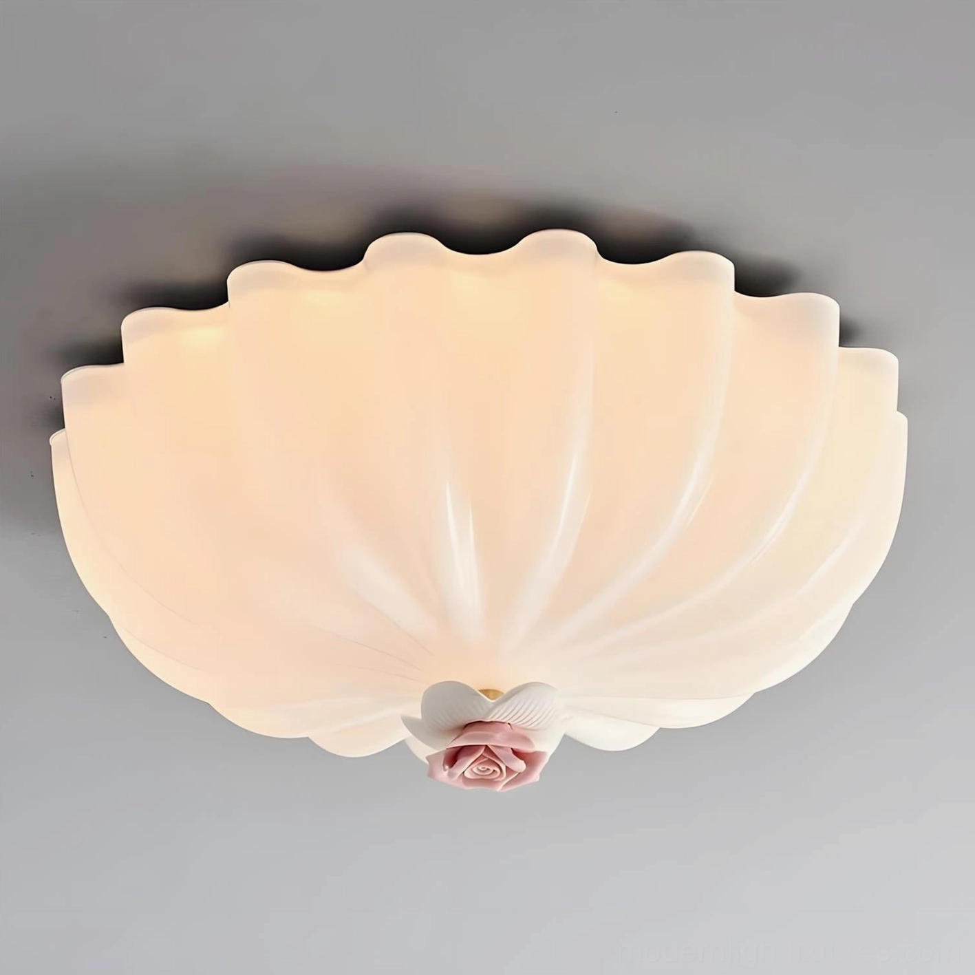Illuminated Belle Coquille ceiling lamp glowing with warm white 3000K LED light, frosted glass shell design with romantic pink floral detail