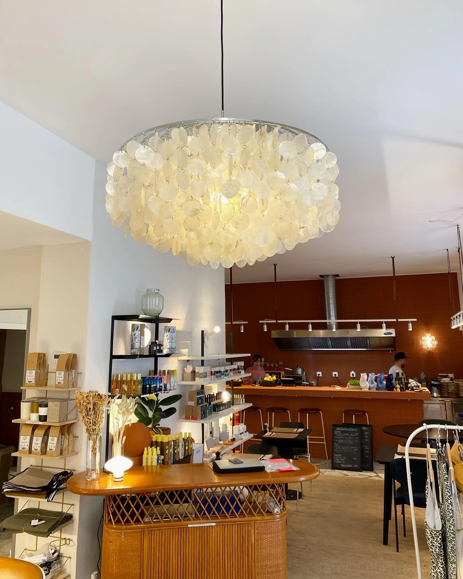 Shell chandelier with gold finish metal frame and cascading white Capiz shell discs