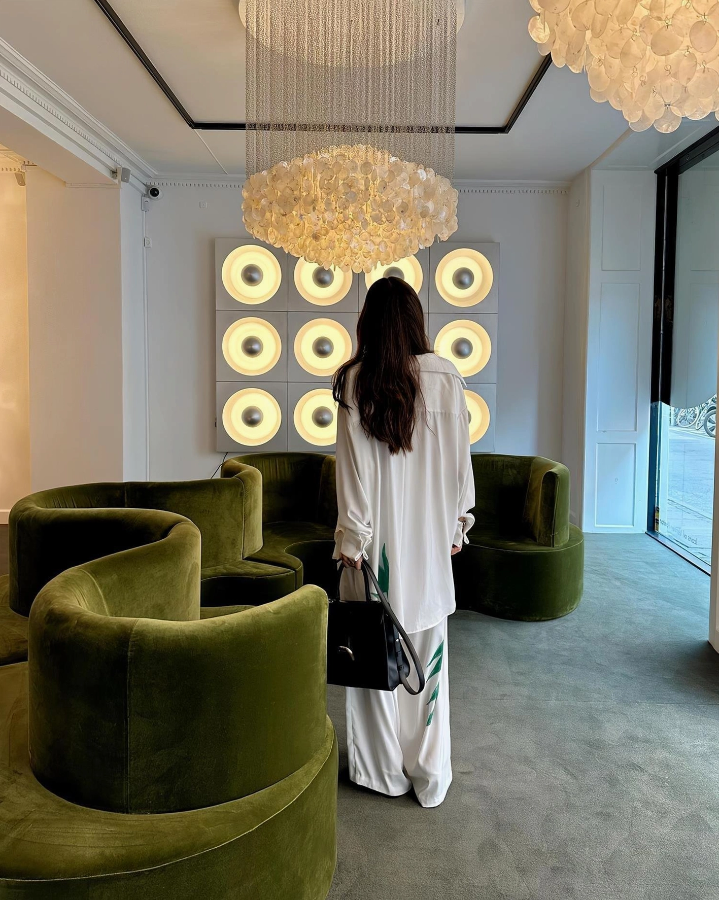White shell chandelier with warm LED illumination creating ambient lighting in contemporary bedroom space