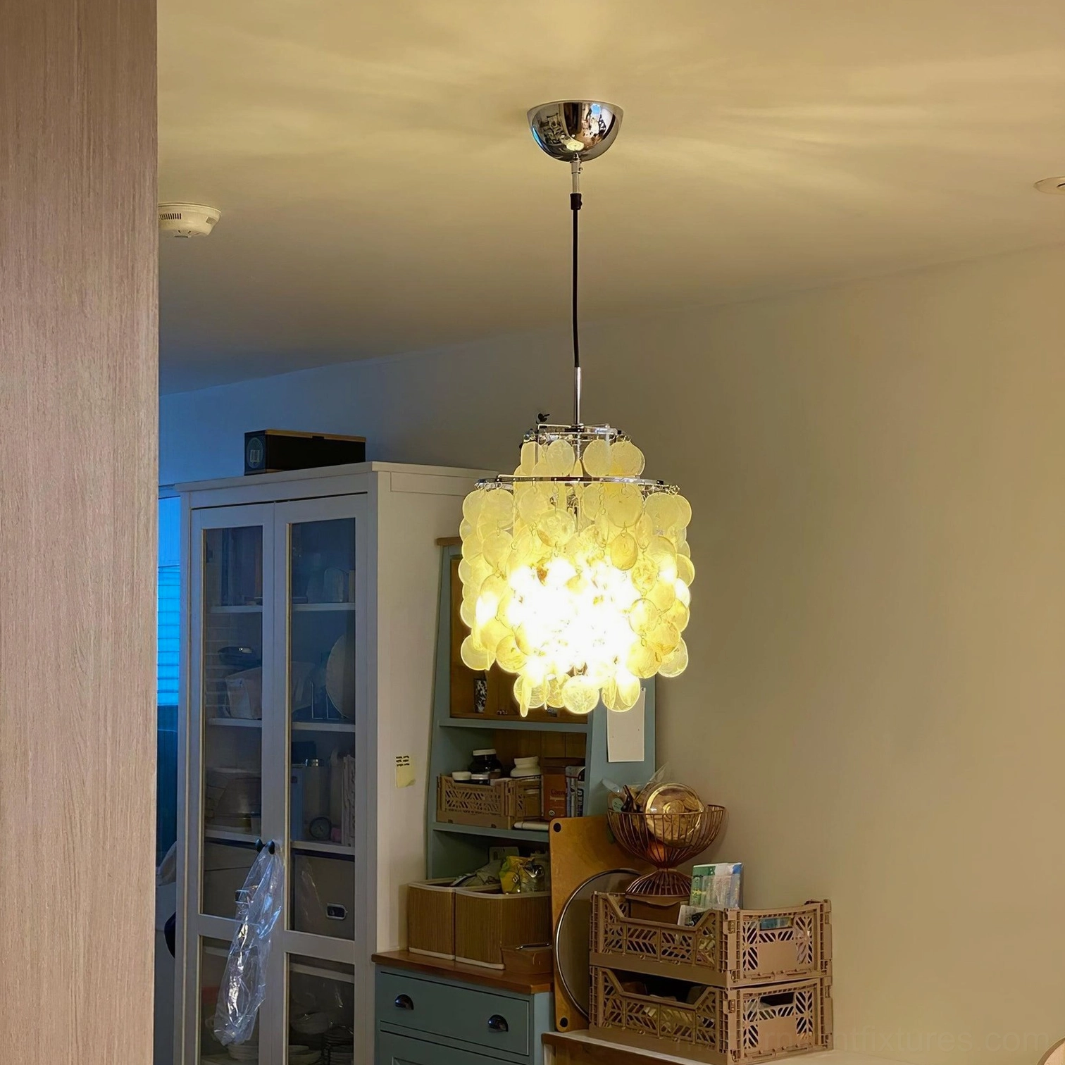 Shell pendant chandelier in entryway foyer with dramatic lighting focal point effect