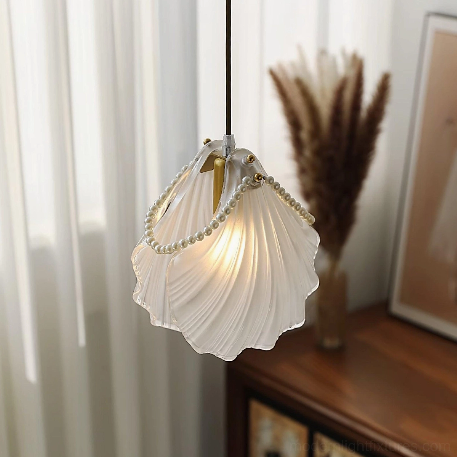 Shell pendant lamp three-quarter view with ruffled frosted glass, gold bead trim, and home decor