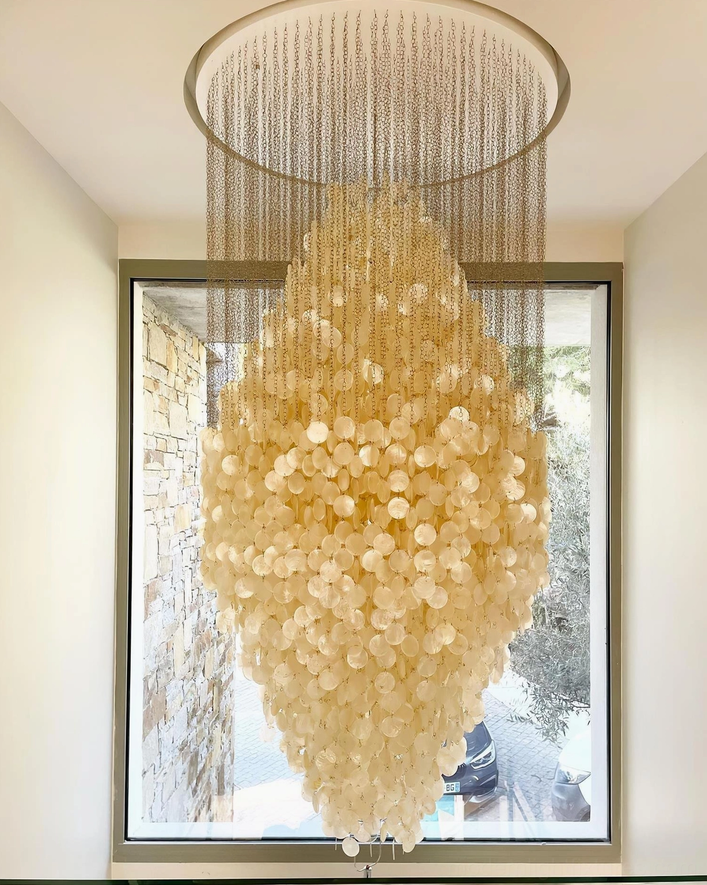 Modern white shell pendant light fixture overhead view with ceiling mount and dispersed shell elements
