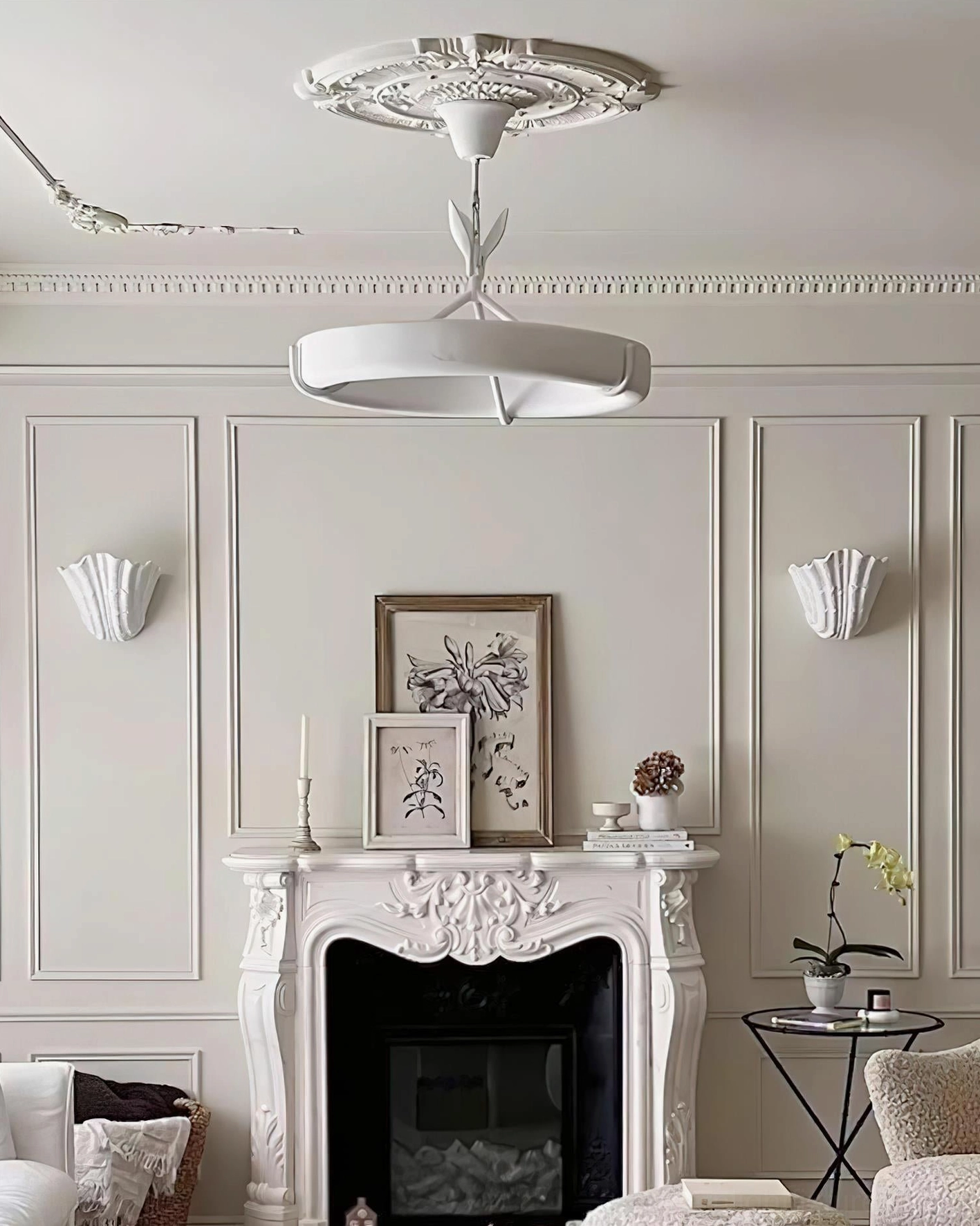 Pair of shell-shaped ceiling mount and wall sconces in French neoclassical living room with ornate ceiling medallion