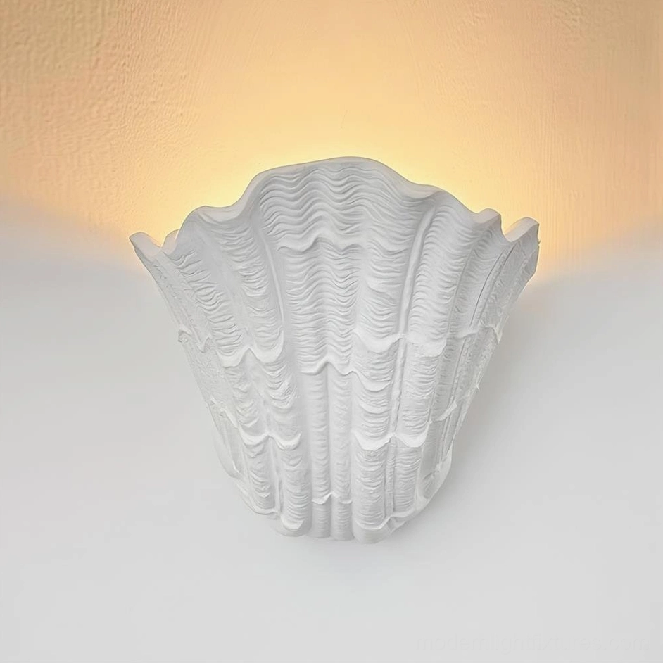 Coastal shell wall lamp mounted indoors with warm ambient backlighting, minimalist Scandinavian interior styling