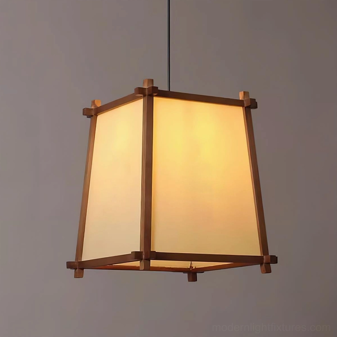 Shizuka trapezoidal pendant lamp close-up front view with solid wood trim and glowing fabric shade