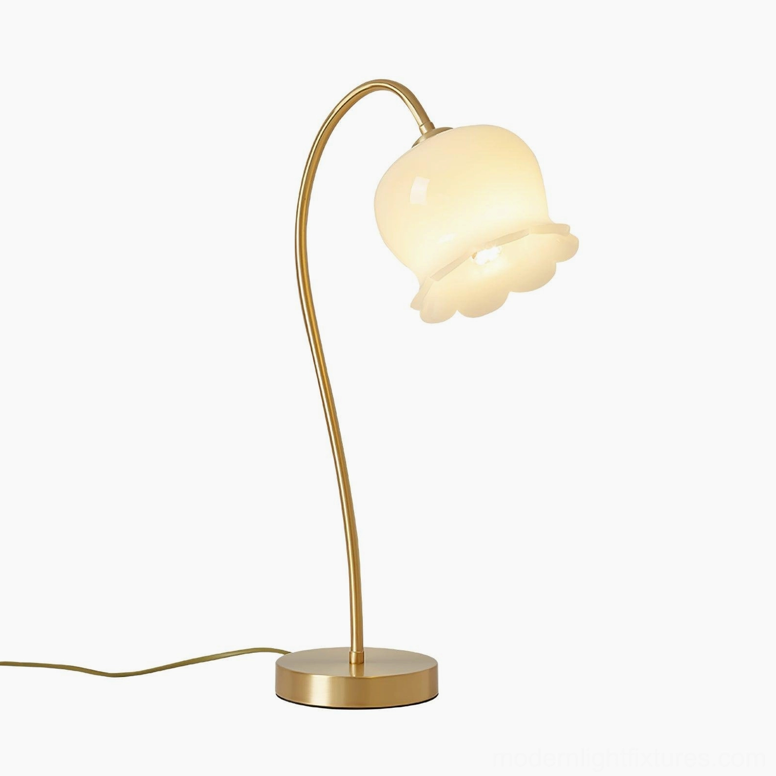 Siena brass table lamp with exposed power cord and push-button switch, yellow brass base with white shade, studio background