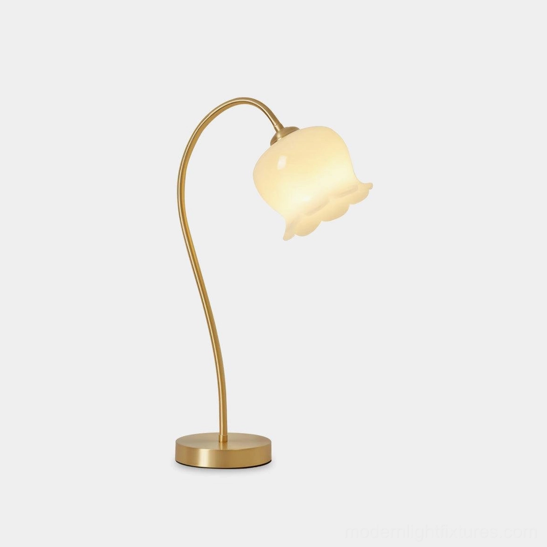 Siena brass table lamp with lily flower design, front three-quarter view, yellow-toned brass base with milky white resin shade
