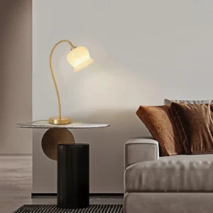 Modern brass table lamp in contemporary living room, positioned on marble side table next to sofa set, warm ambient lighting