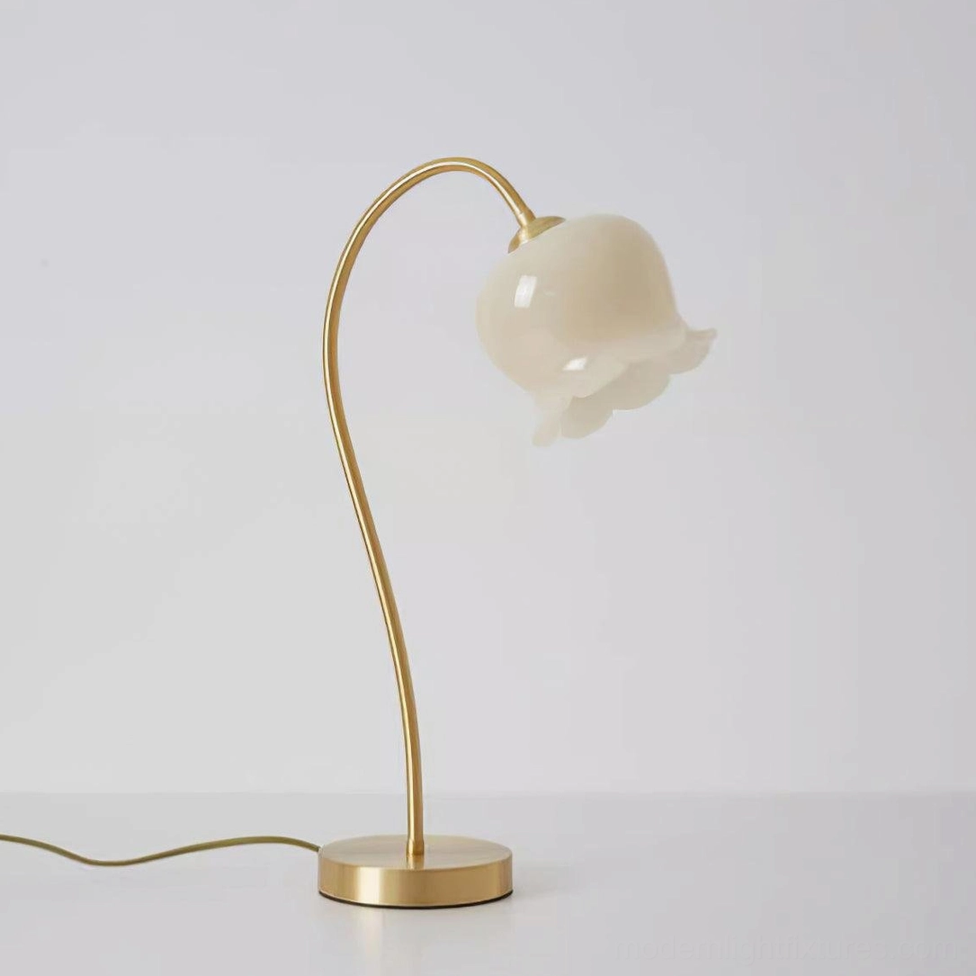 Brass table lamp product showcase, yellow-toned brass construction with white resin shade, elegant sculptural form