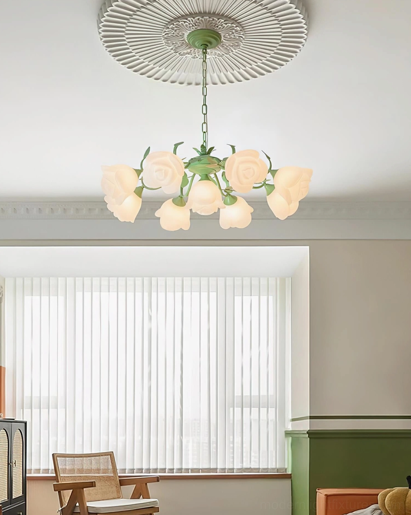 French Siena Rose Chandelier hanging above seating area with window blinds, green metal branches with frosted rose shade lighting