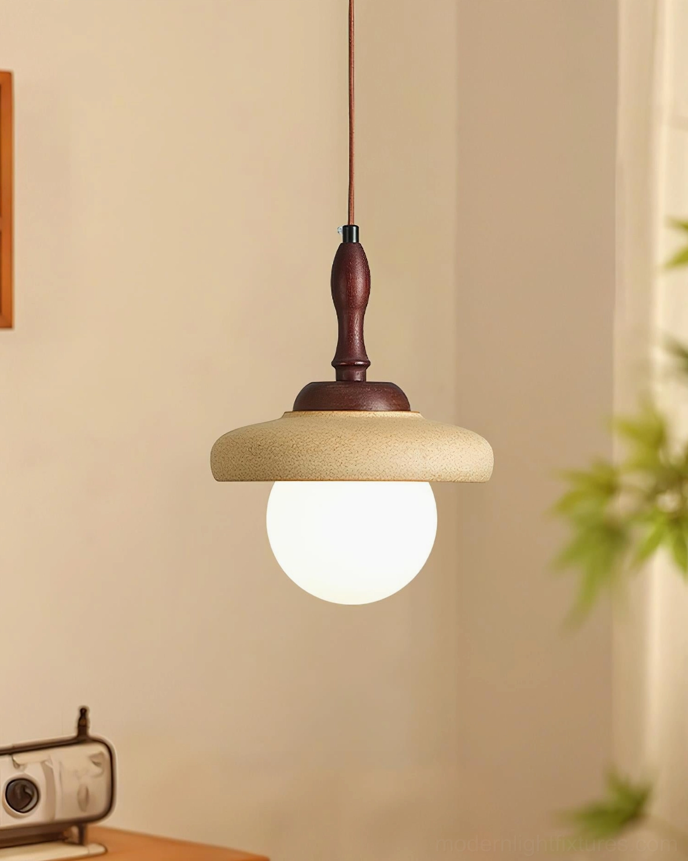Minimalist beige ceramic pendant lamp with wavy contoured edge and wood hanging rod - corner view