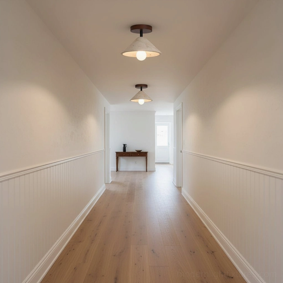 Multiple Sierra travertine ceiling lights creating uniform ambient lighting in residential hallway corridor