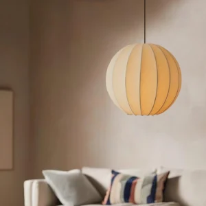 Silk pendant light installed in contemporary living room with warm beige shade and black hanging cord