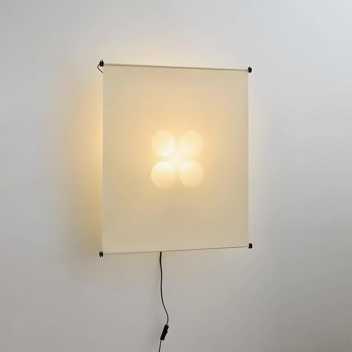 Silque Washi paper wall sconce illuminated front view, cream-colored fabric screen with four-bulb LED array, black metal hardware and power cord