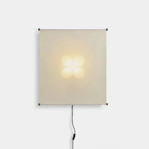 Silque Washi paper wall sconce front view, cream fabric shade with warm LED lighting, black metal frame and power cord on white studio background
