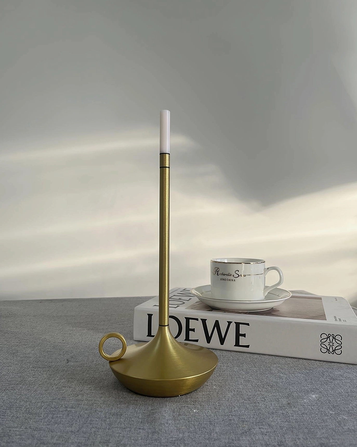 Silver finish LED candle table lamp in modern bedroom setting providing warm bedside ambient illumination