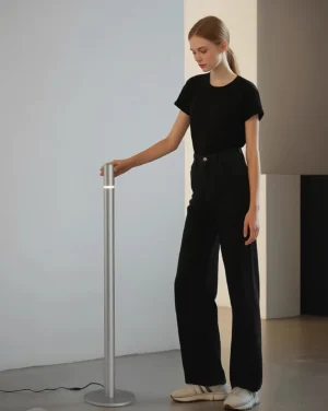 Silver Obelisk LED floor lamp with touch control in modern living space, eye-level perspective