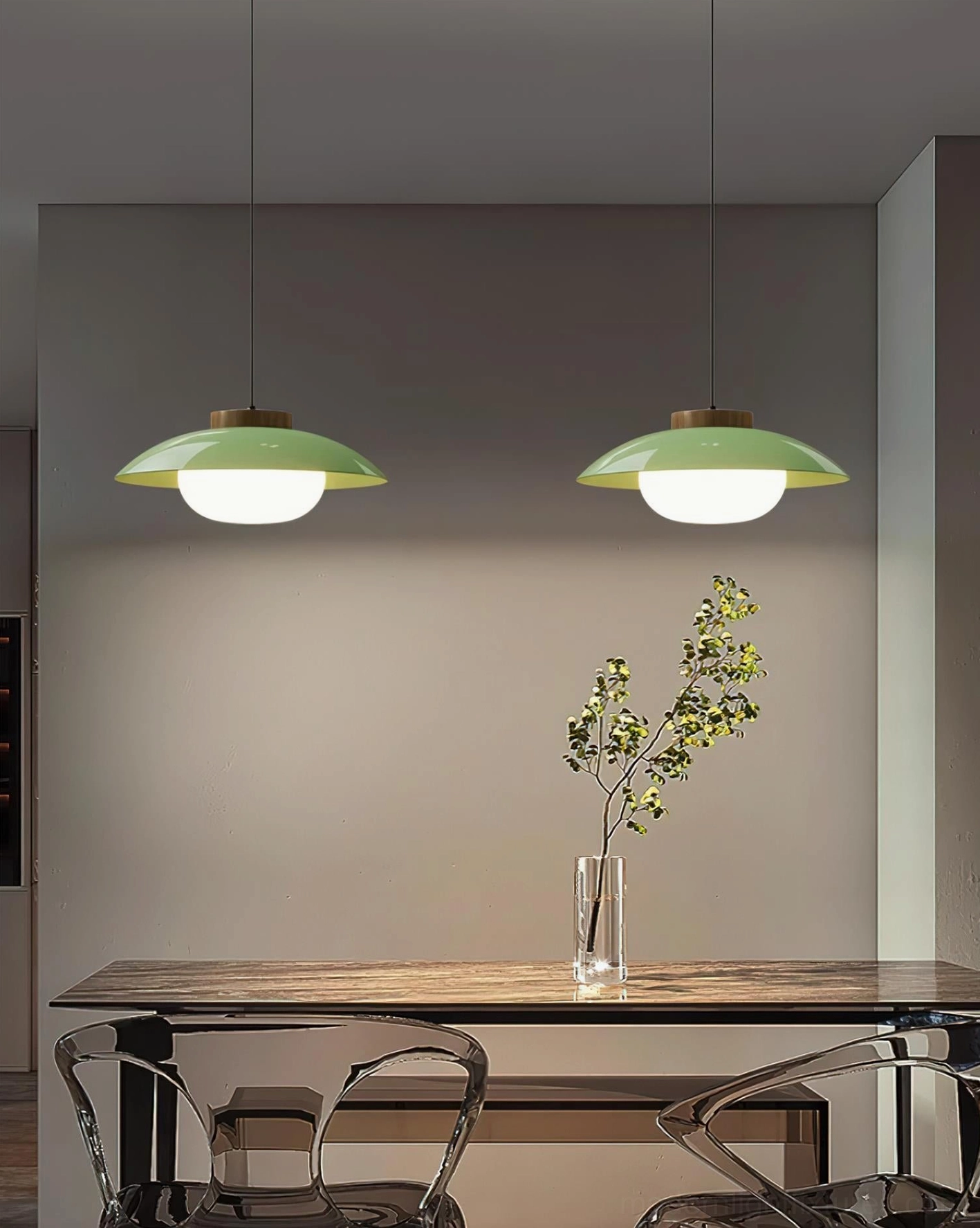Mixed color Sima pendant lamps—one sage green and one white—suspended above wooden dining table, contemporary minimalist dining lighting