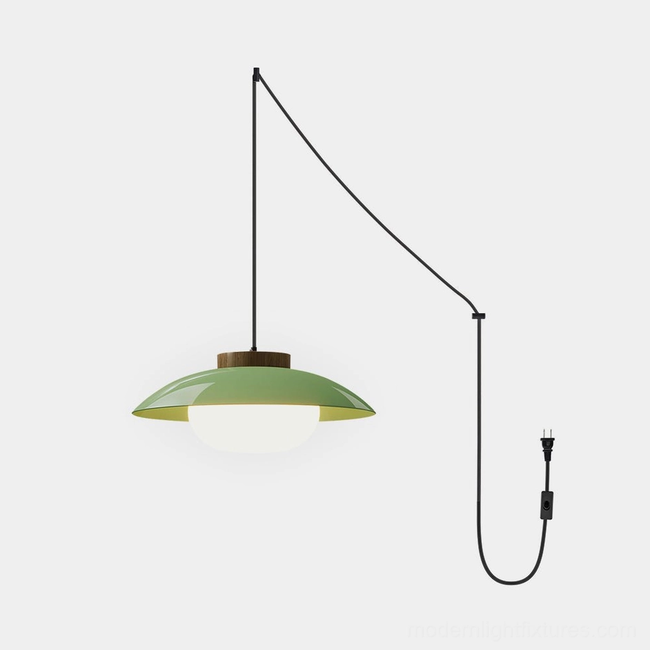 Sima modern plug-in pendant lamp with sage green saucer shade and warm wood top accent detail, front view against white background