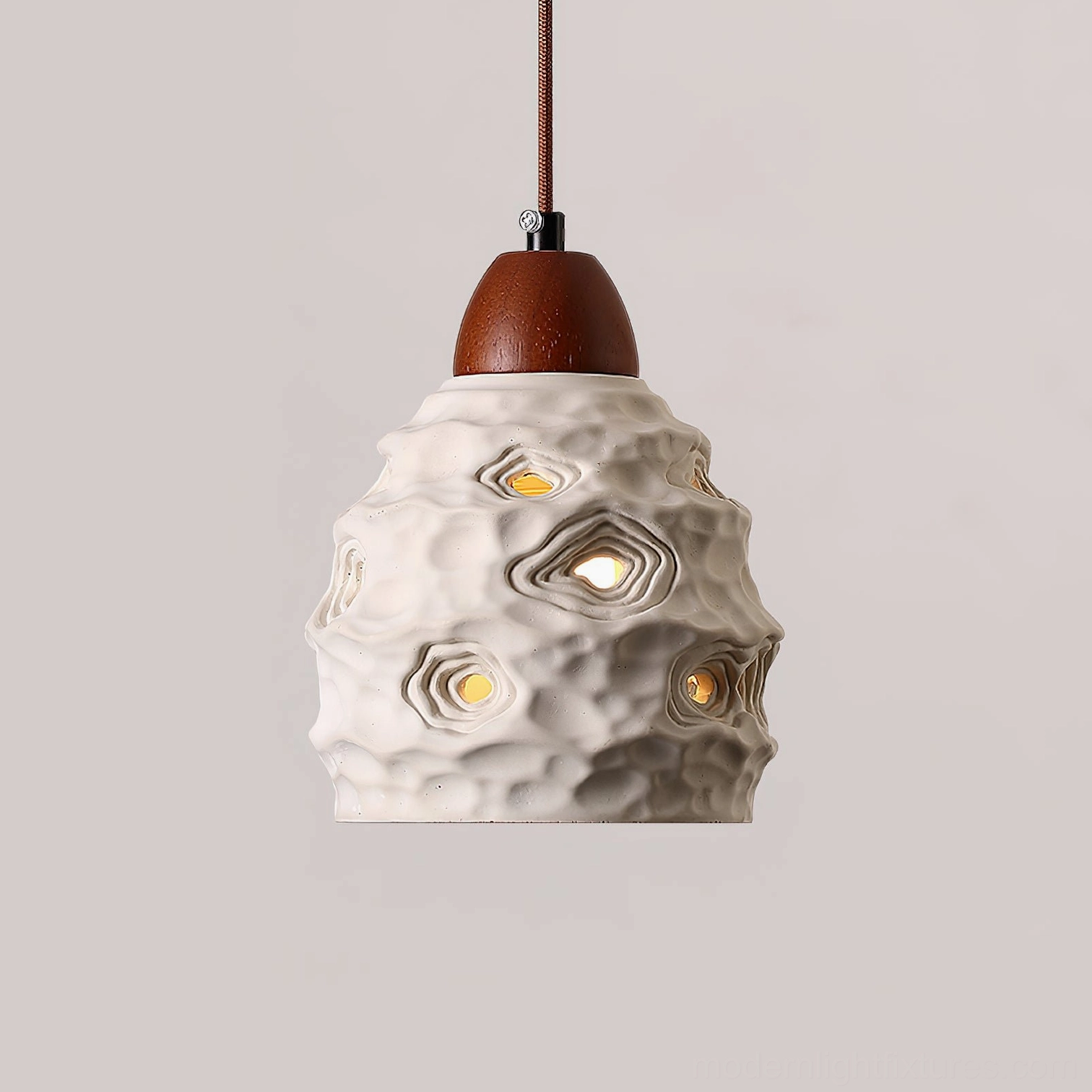 Single ceramic pendant light fixture with adjustable hanging height and walnut wood top accent - product lifestyle shot