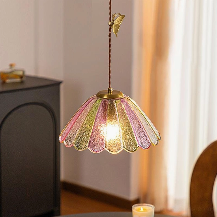 Single head butterfly pendant lamp with scalloped glass shade and brass butterfly ornament, dining room interior
