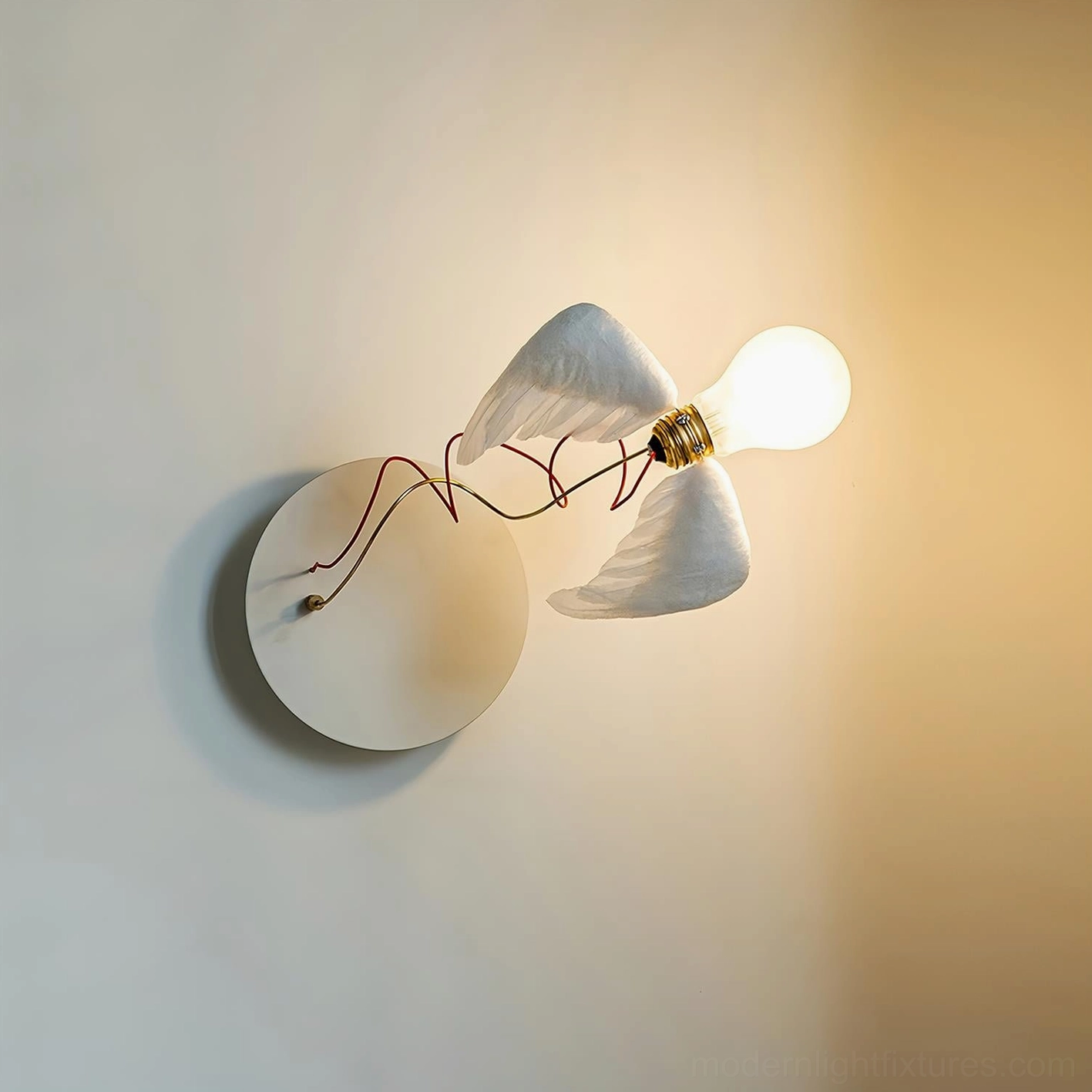 Single-head feathered wall sconce with white finish and warm glow on neutral background