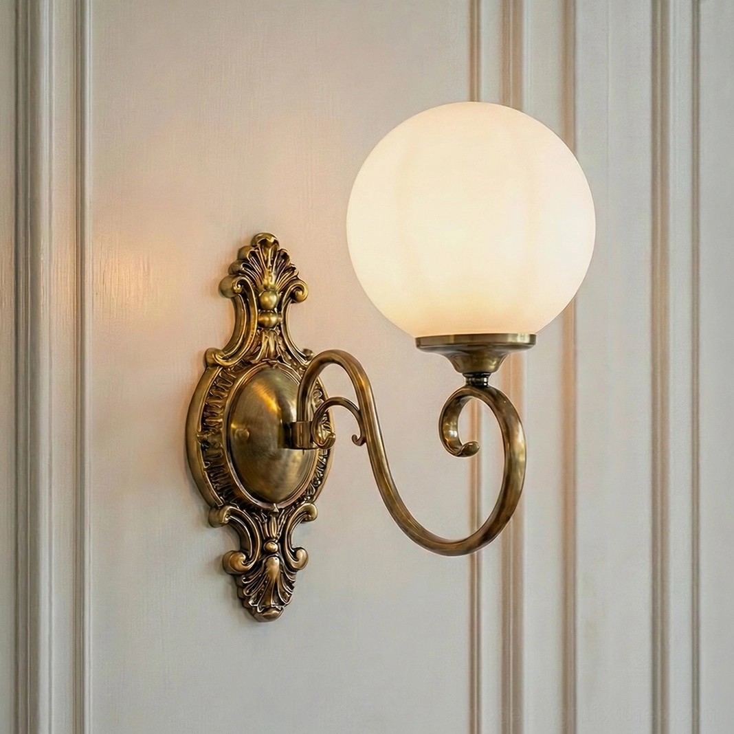 Single-head ornate brass wall sconce with white glass globe, classic baroque backplate design
