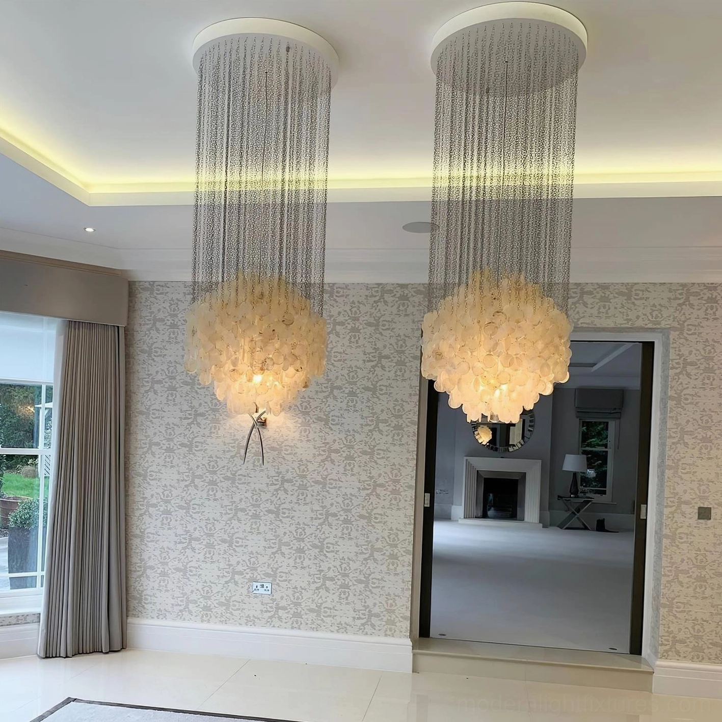 Single-layer capiz shell pendant chandelier in modern living space with natural light and architectural elements