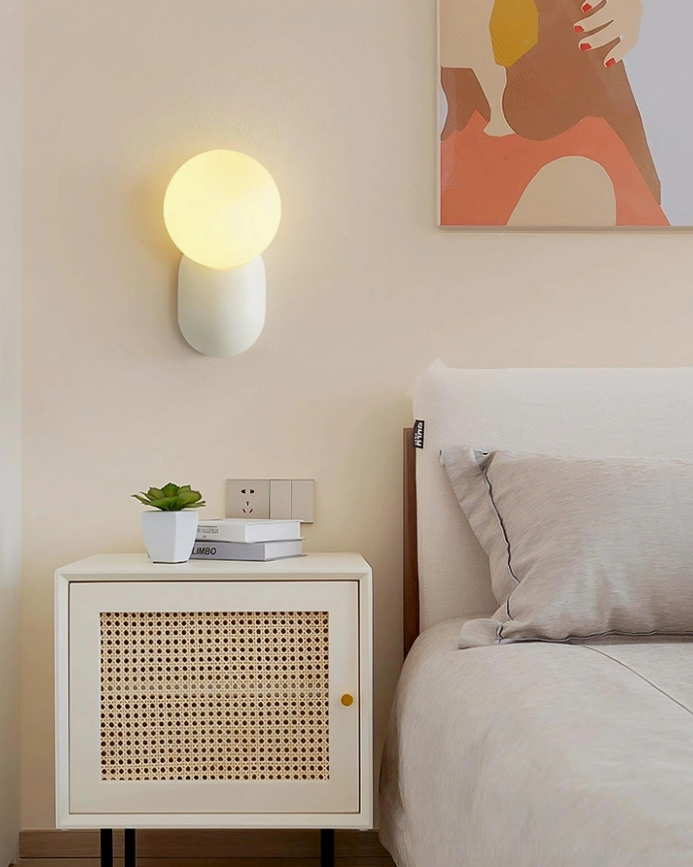 Single spherical wall sconce installed in bedroom bedside corner providing soft accent illumination, neutral tone