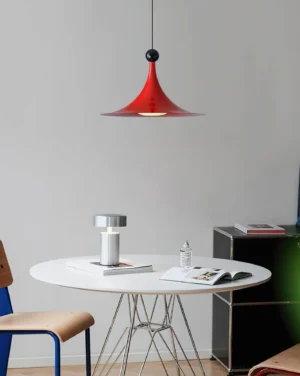 Sirocco red pendant light with matte finish hanging in modern dining workspace, overhead perspective view