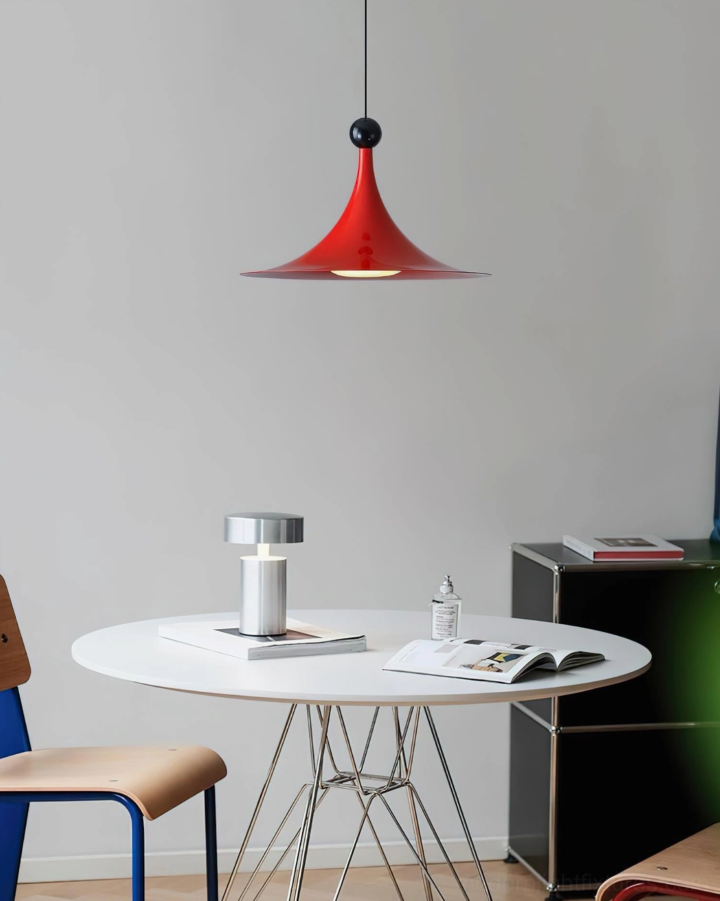 Sirocco red pendant light with matte finish hanging in modern dining workspace, overhead perspective view