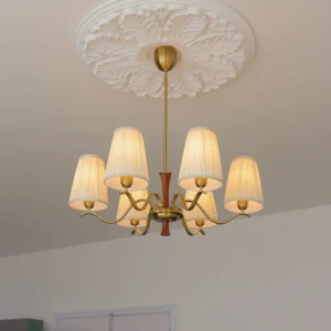 6-light fabric chandelier installed on ceiling medallion, viewed from below showing warm brass finish