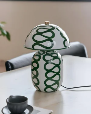 Modern ceramic table lamp with spiral artistic design displayed on dining table with coffee cup