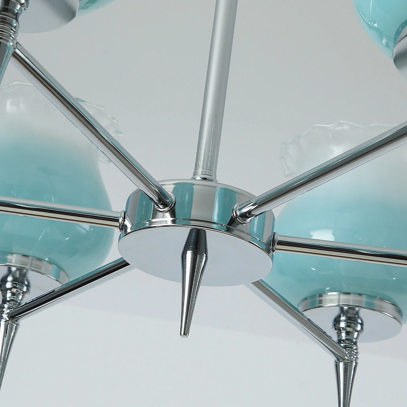 Skylin 4-arm compact chrome chandelier configuration shown in intimate dining space with vintage furnishings