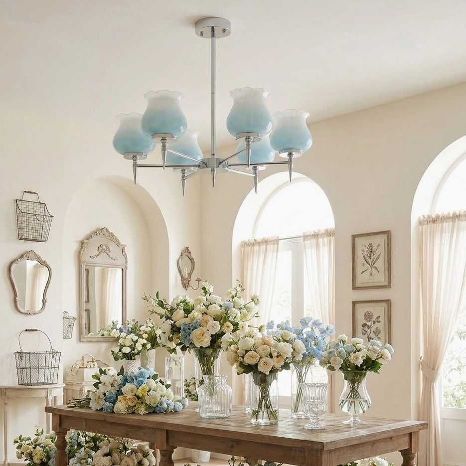 Skylin multi-arm chrome chandelier with white frosted tulip shades in vintage dining room with arched windows and rustic furniture