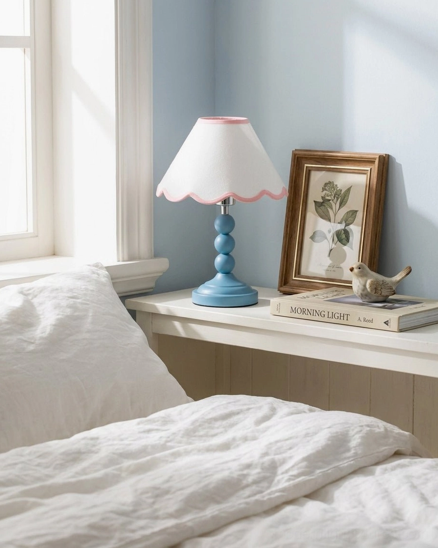 Skylisse table lamp detailed close-up view showing scalloped white fabric shade with pink trim and sky-blue metal base
