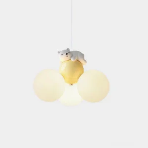 Sleeping bear pendant lamp with frosted glass globes emitting warm light in minimalist studio setting