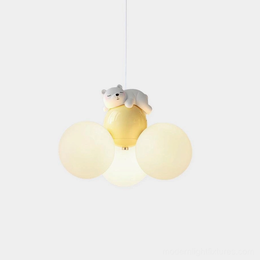 Sleeping bear pendant lamp with frosted glass globes emitting warm light in minimalist studio setting