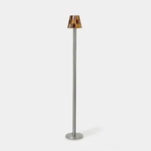 Slim stained glass mosaic floor lamp with narrow silver metal stem and amber-mahogany checkerboard glass shade on white background