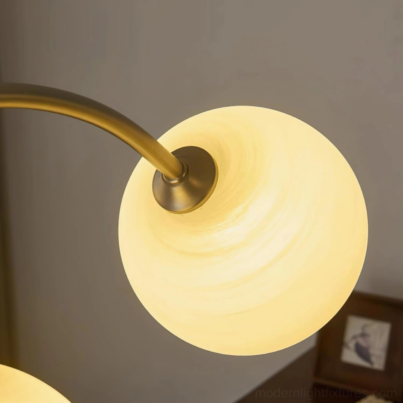 Modern arc chandelier creating ambient lighting in residential interior space design