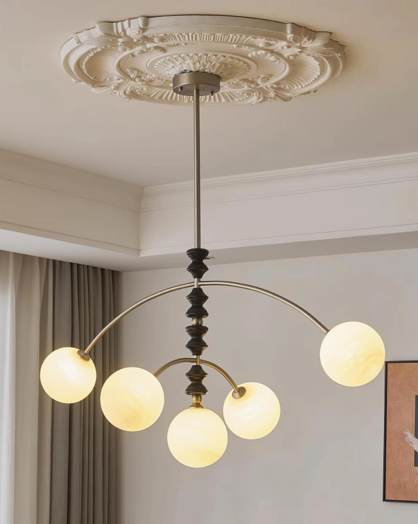 Multi-head arc pendant light with bronze hardware and spherical glass shades in residential interior