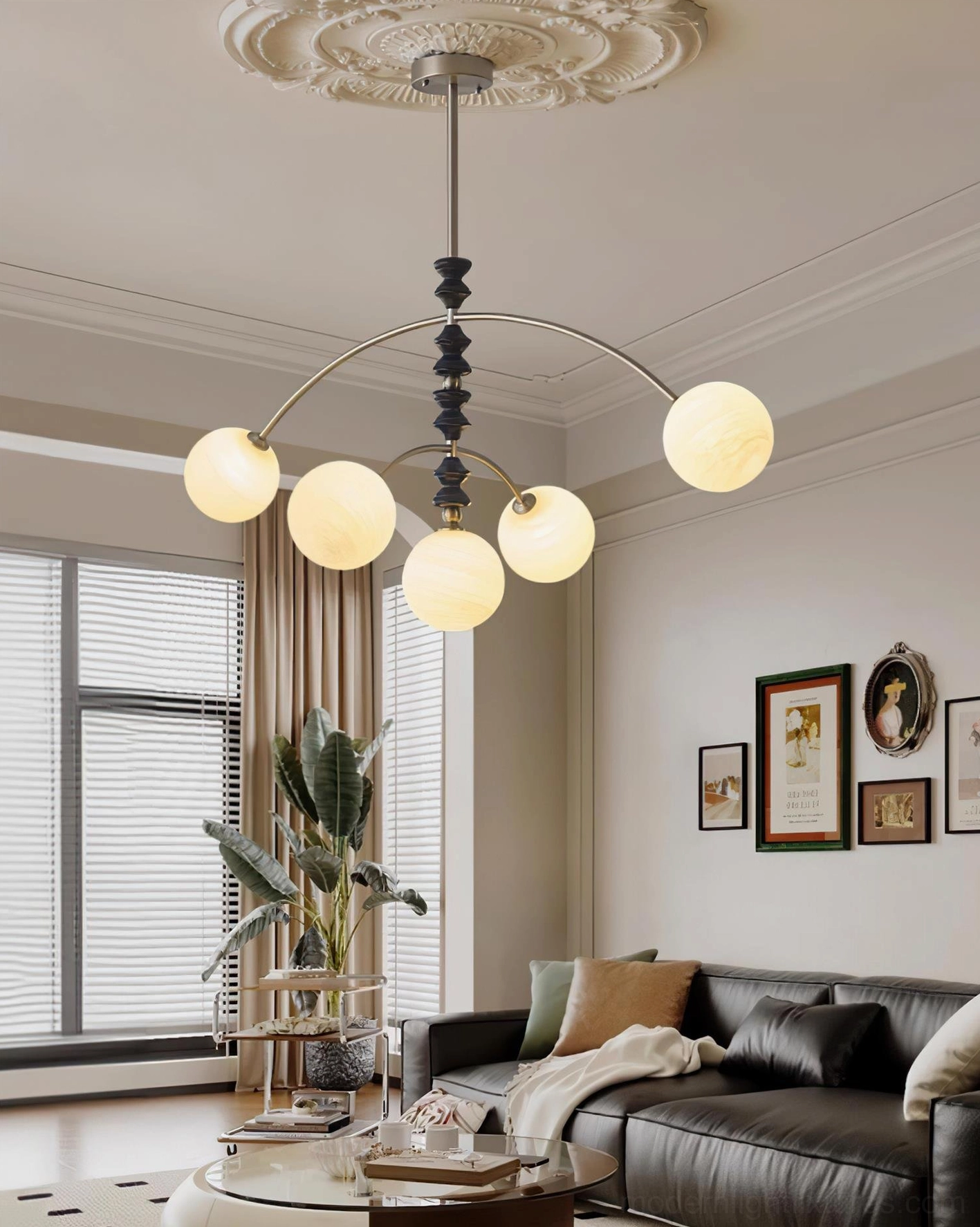 Contemporary arc chandelier displayed in modern family living room with leather sofa seating