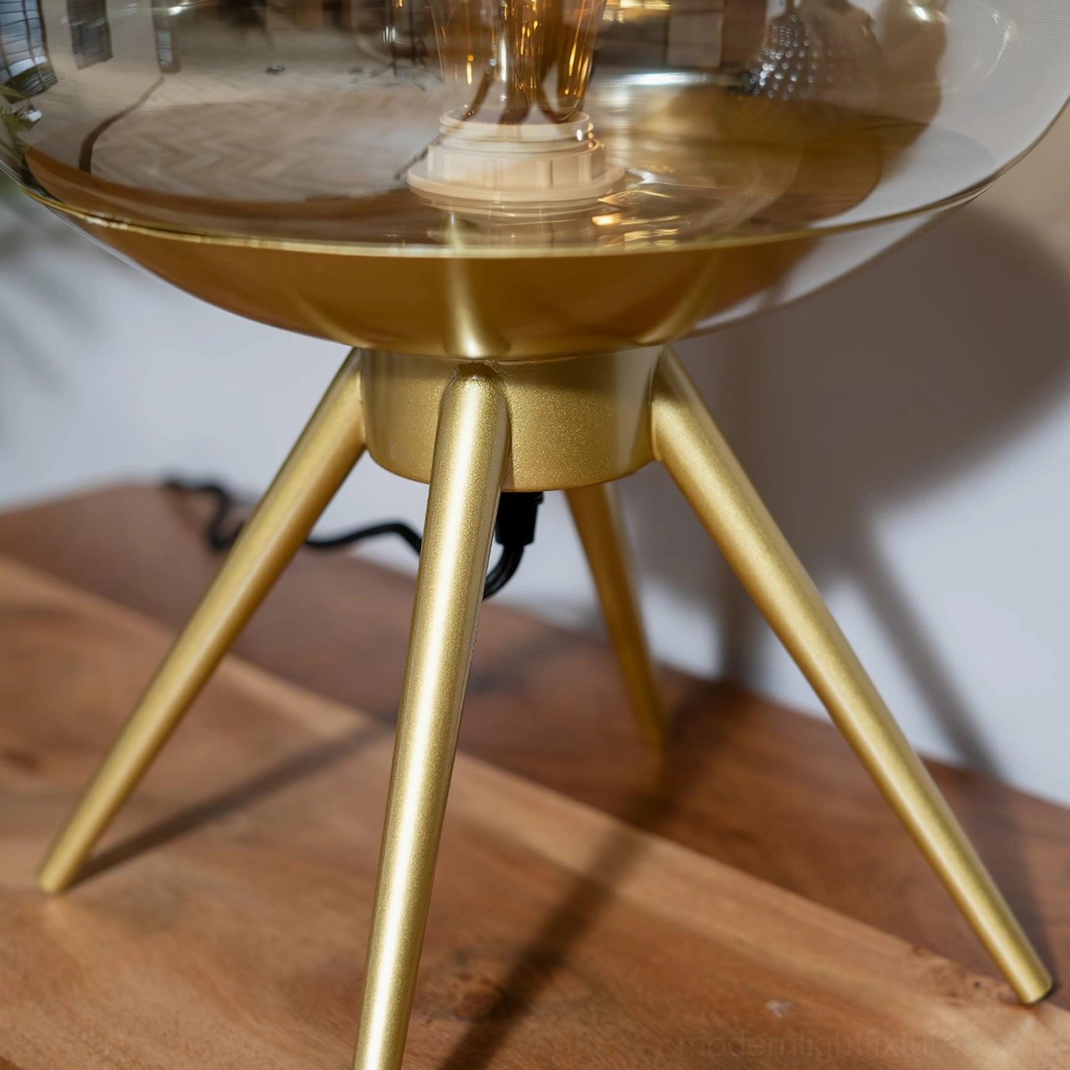 Smoke gray modern table lamp with tiered glass shade and exposed vintage-style bulb close-up