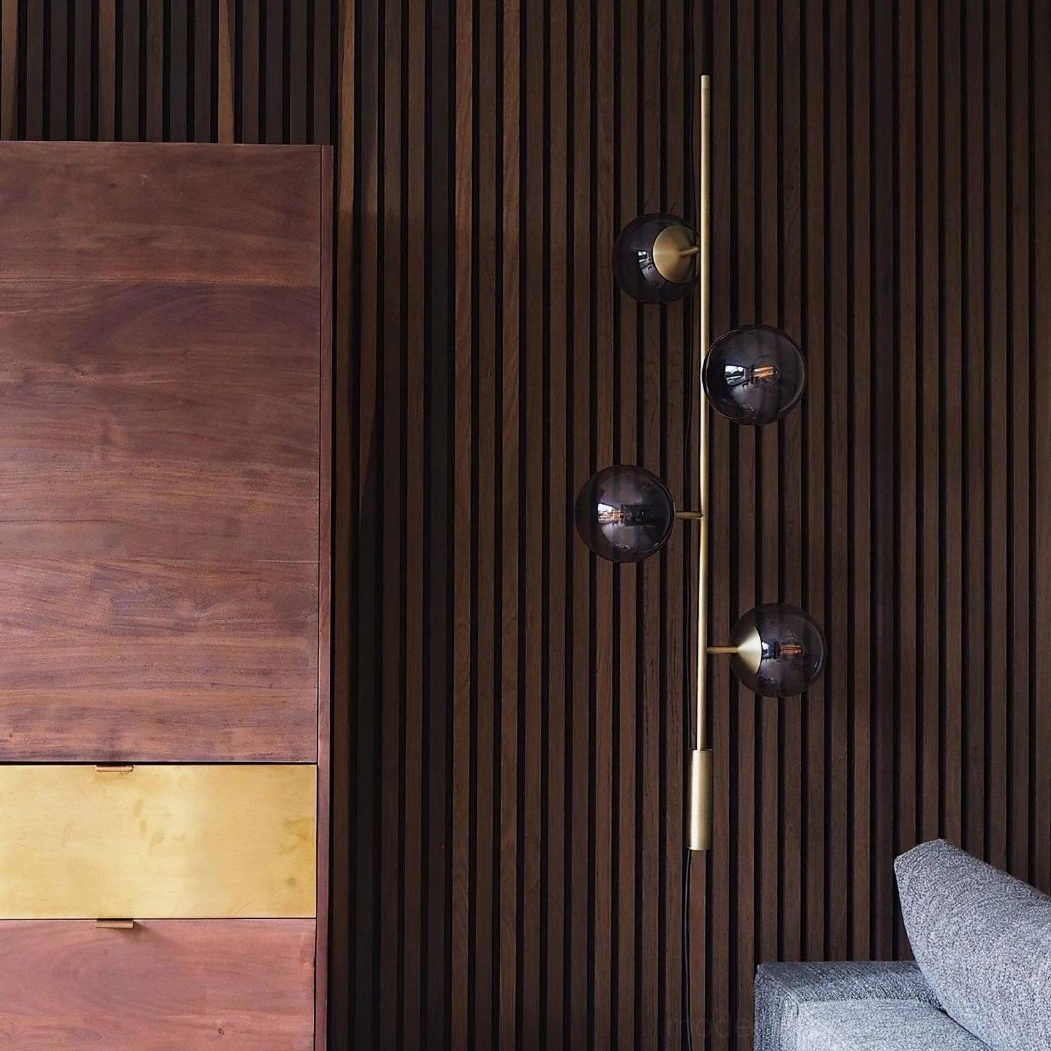 Contemporary smoked glass orb pendant chandelier creating ambient lighting in modern lounge