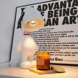 Snoopy candle warmer table lamp front view with lit bulb on desk with typographic décor
