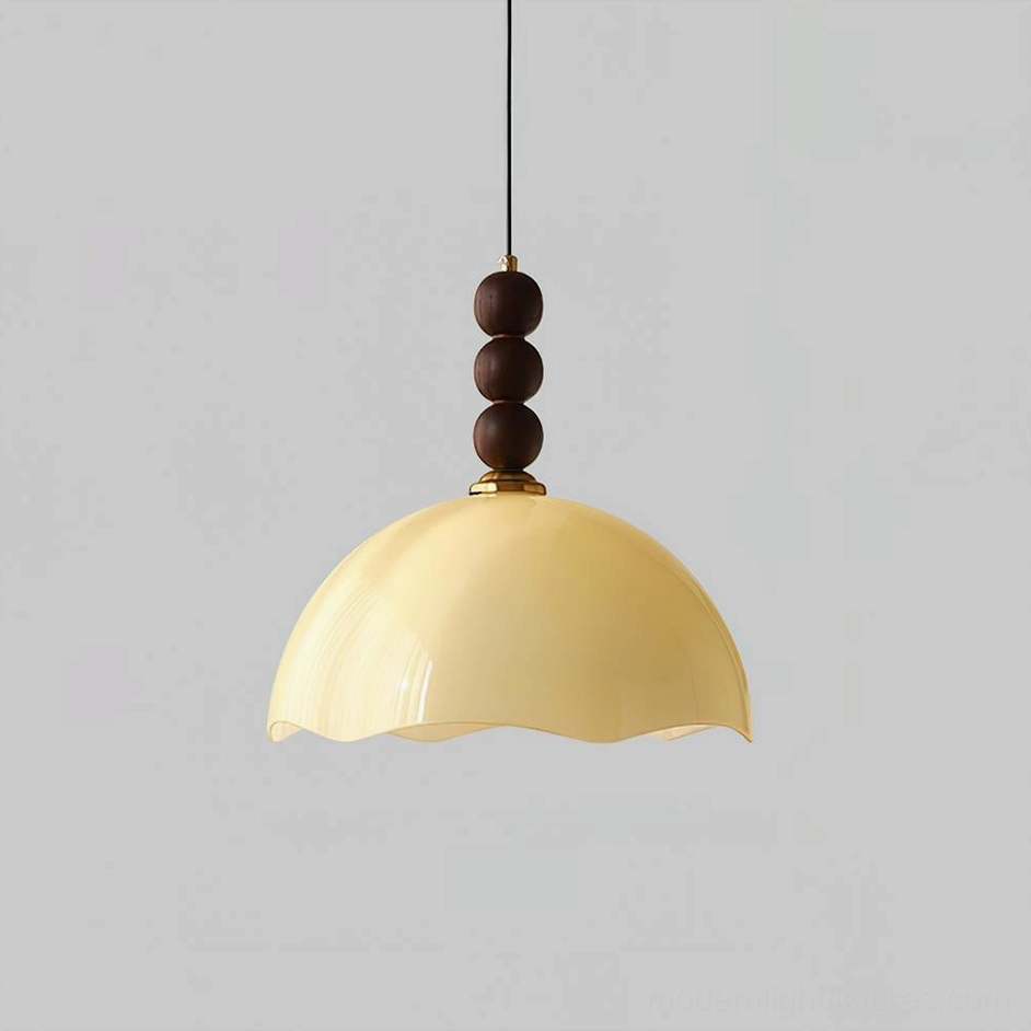 Soft beige rippled glass pendant light with vertical walnut bead stack creating organic modern silhouette