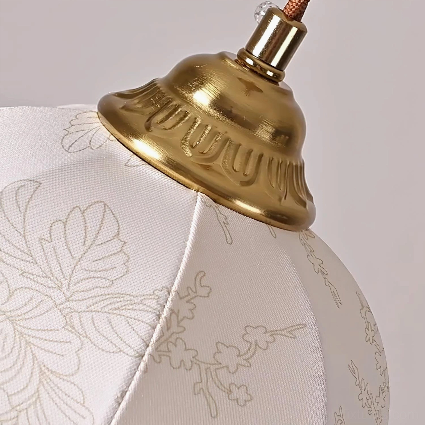 Soft-glowing fabric pendant fixture with off-white color and brass accents for warm ambient lighting