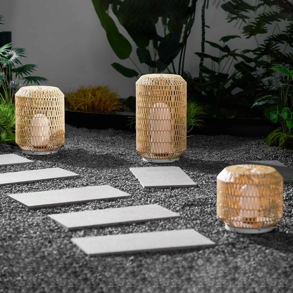 Solar-powered woven rattan outdoor lamp demonstrating cord-free eco-friendly installation